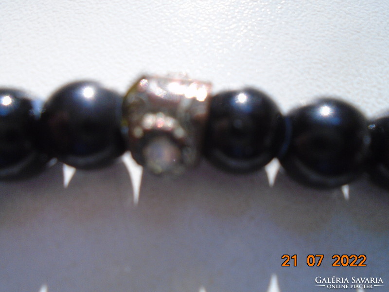 Black pearl bracelet with an interesting handcrafted bronze pearl decorated with 2 polished moonstones