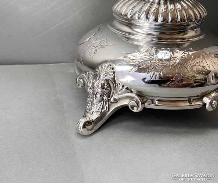 Decorative silver table base.