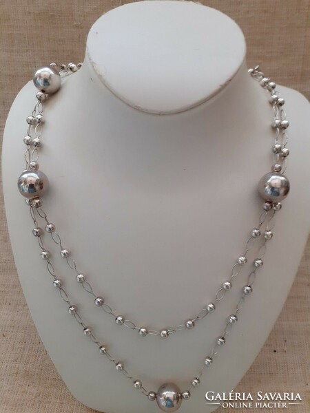 Silver-plated long necklace made of small and large balls with elaborately soldered eyes