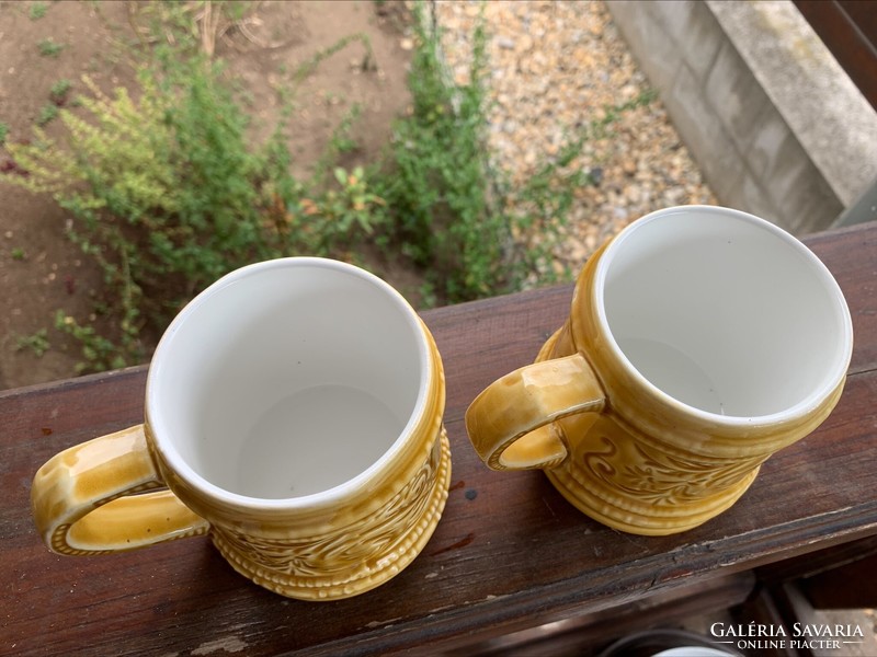 Pair of granite mugs/jugs with cheeky pointed human depictions, 2 pcs. Mustard yellow