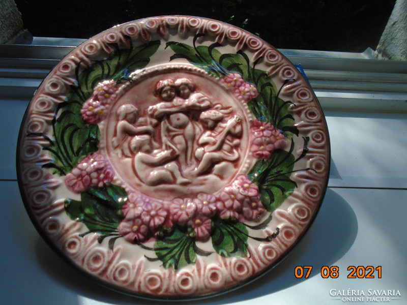 19th century baroque Spanish majolica wall plate with raised musical puttos and flowers
