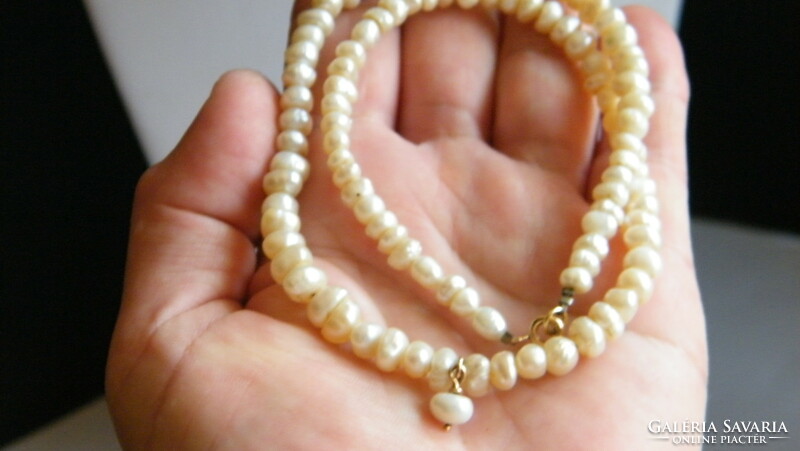 Old freshwater cultured pearl necklace with 14 arm clasps and pendant.