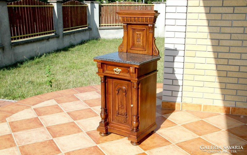 Bedside table with a marble top with a tin-carved superstructure