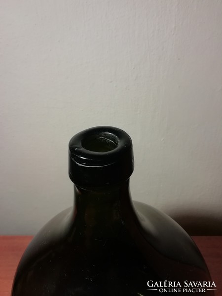 Large dark green wine bottle with demizon