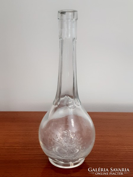 Old brown glass liquor bottle with convex inscription