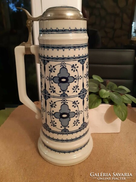 A giant ceramic jug with a tin lid with a ceramic insert