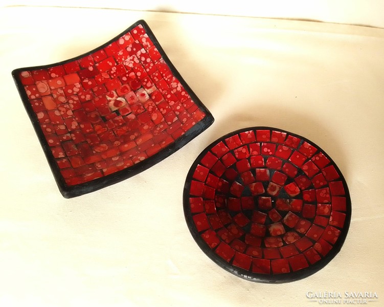 A pair of round and square glass mosaic black and red painted candle holders and candle holders on a plaster base