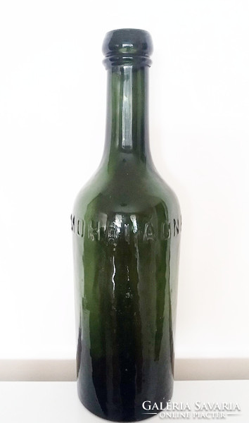 Old bottle of mossy magnes source with inscription mineral water in green glass