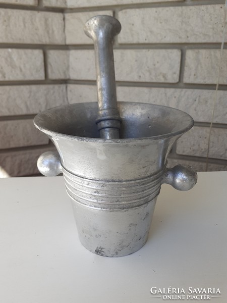 Old aluminum mortar and pestle with confectioner tool