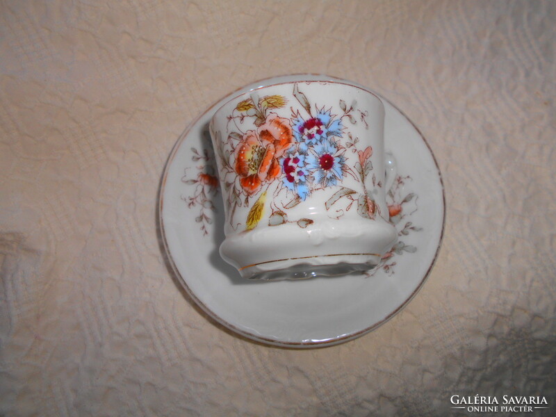 Hand painted porcelain tea cup and saucer