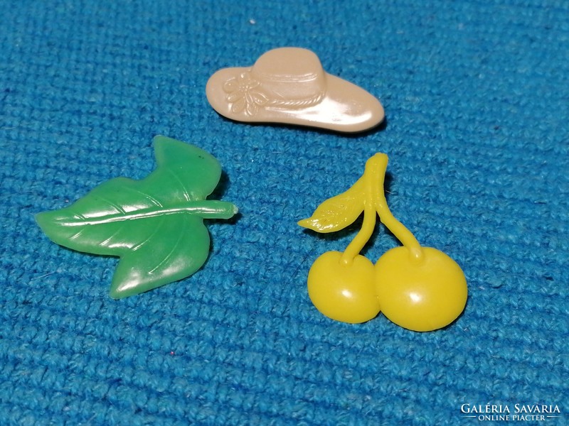 Old plastic badges, hat, cherry, leaf (436)