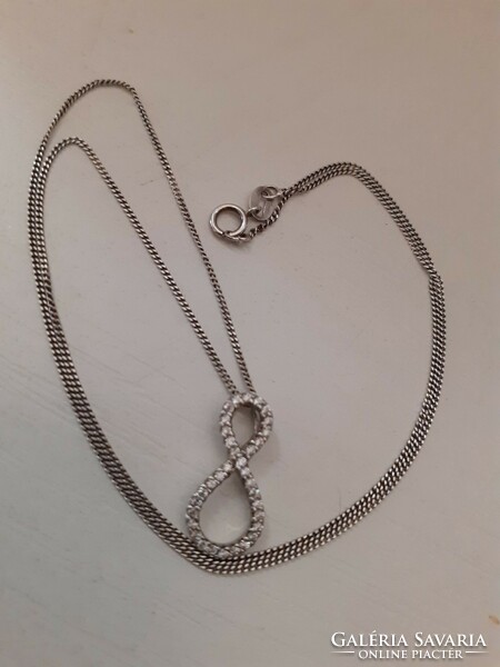 Marked silver chain with a mark on it and a sparkling tiny cubic zirconia stone infinity sign pendant