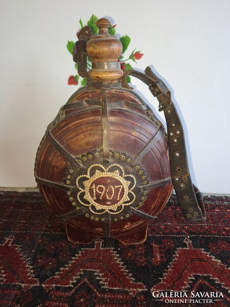 Antique wooden water bottle decorated with leather