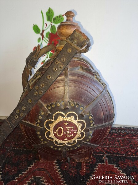 Antique wooden water bottle decorated with leather