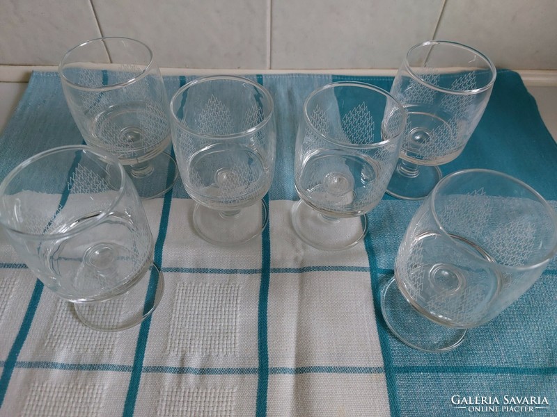 A set of engraved glass drinking glasses with a polished base, made in the 1970s