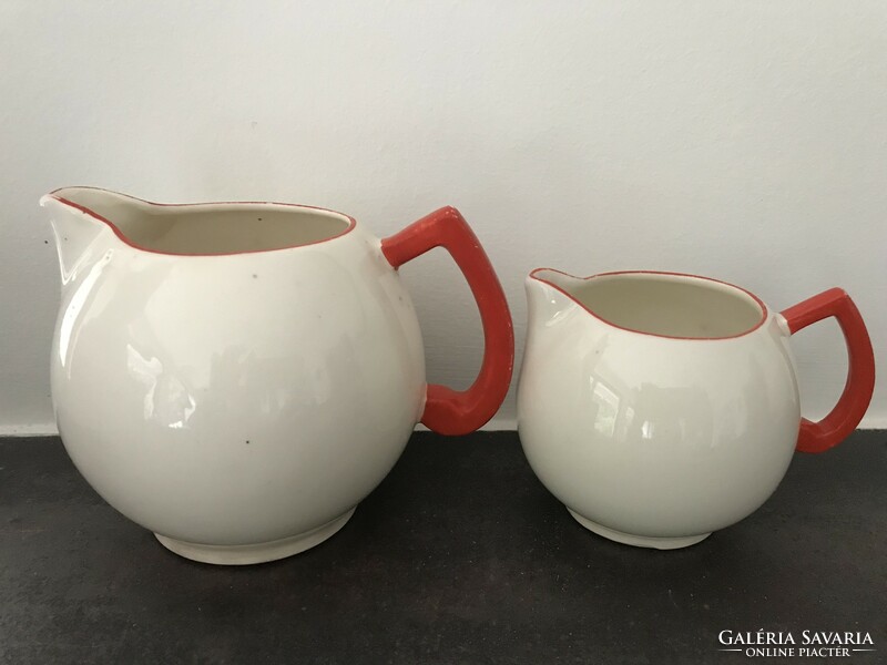 Art deco Czech ceramic pitchers in eggshell color with bright red handles