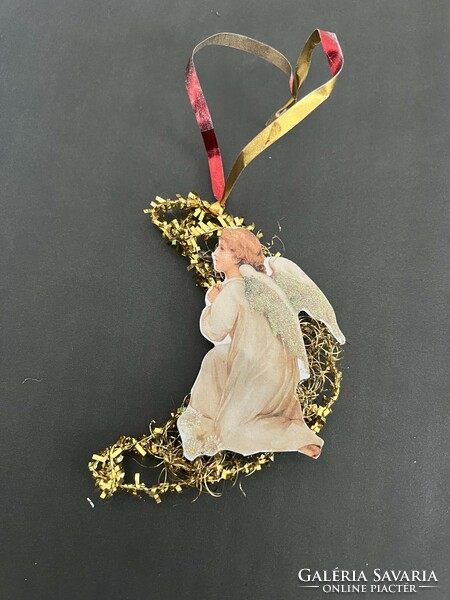An angel on the moon is a Christmas tree decoration composed of old and new elements