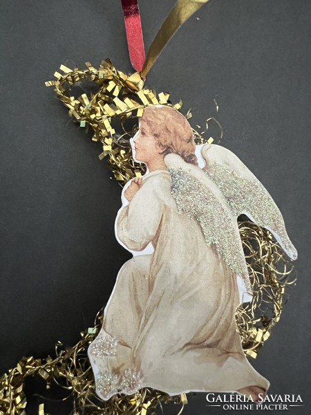 An angel on the moon is a Christmas tree decoration composed of old and new elements