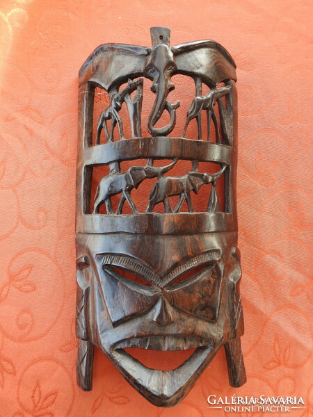 African hand carved wooden wall mask decorated with elephants and giraffes