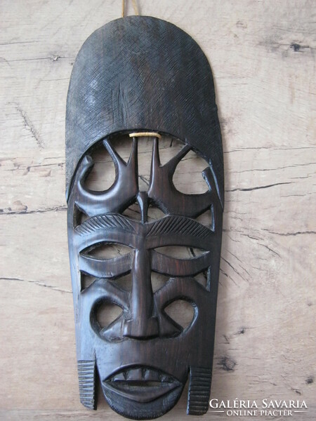 Wooden mask with exotic wall ornament