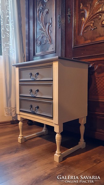 An old bedside table or a small dresser..