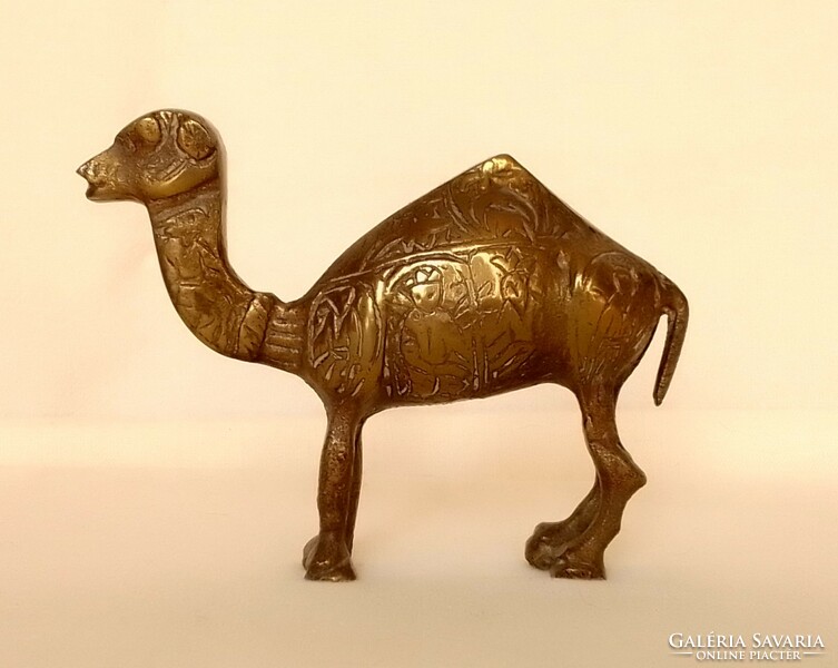 Old copper one-humped camel dromedary animal figure statue with carved pattern on the side of Arabian African desert