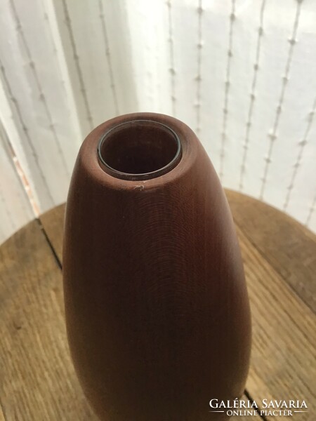 Old modern wooden vase with glass tube inside