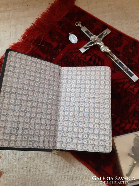 Old German Christian heirloom prayer book in a box with mother-of-pearl rosary with relics on a small tablecloth