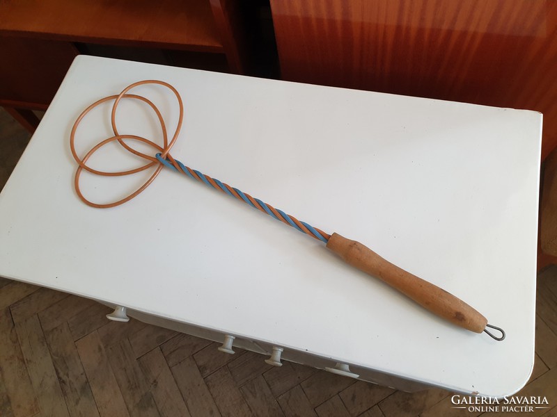 Old retro household appliance with wooden handle duster