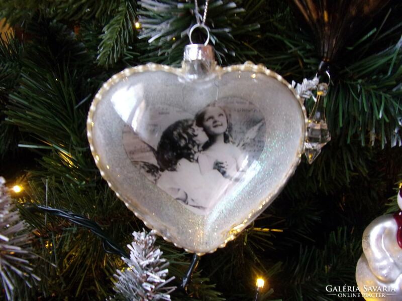 A glass, nostalgia ornament depicting a mother and daughter