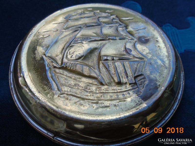Small copper decorative plate with a convex sailing ship