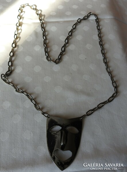 Silver-plated mask pendant on a chain