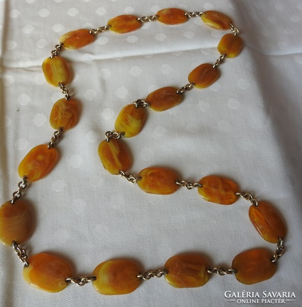 A string of pearls made of amber-looking flat stones - necklace
