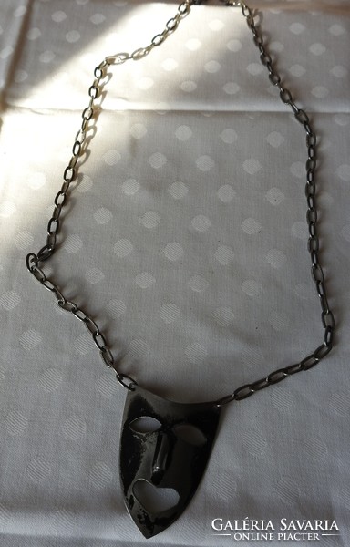 Silver-plated mask pendant on a chain