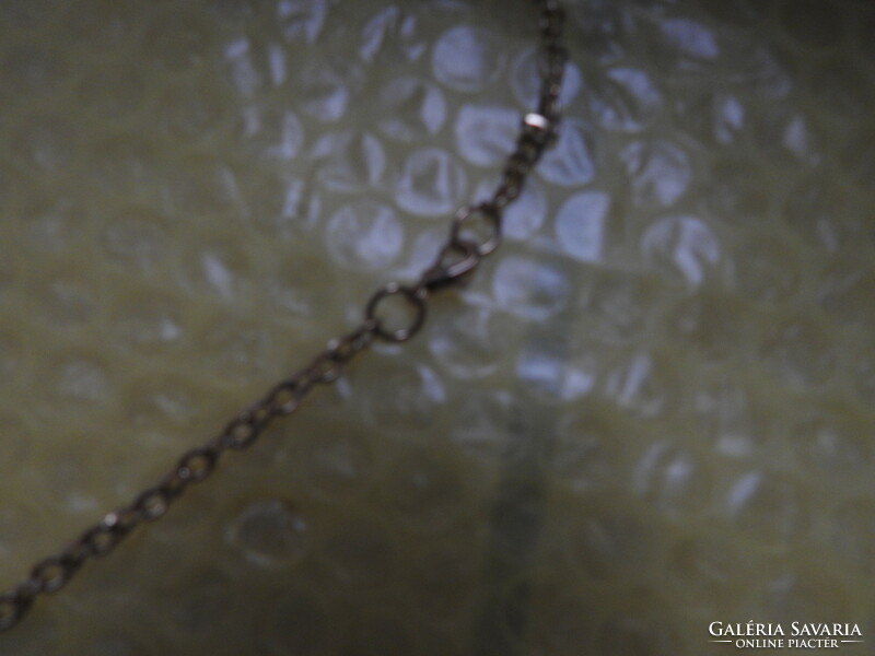 Golden daisy pendant on a chain