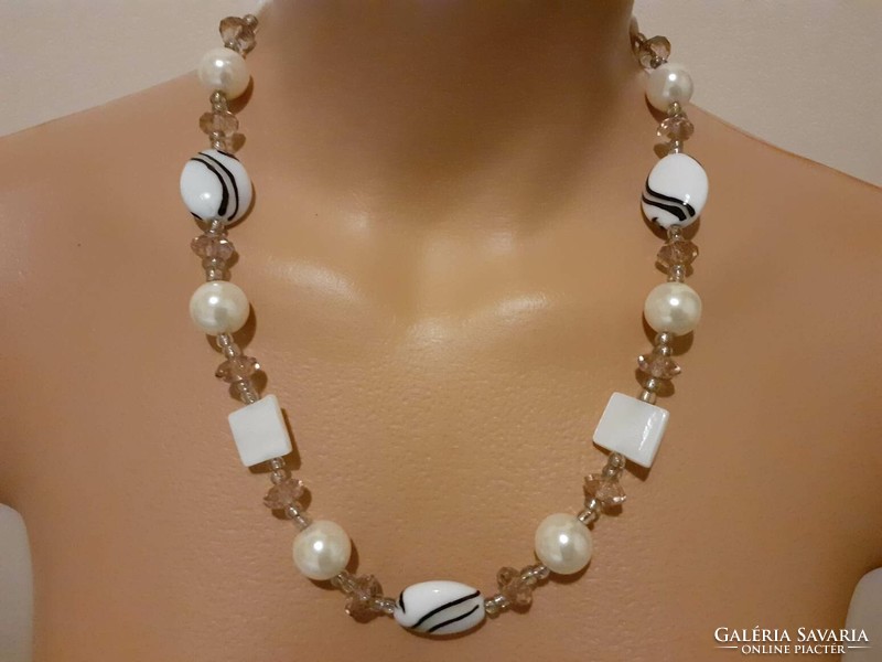 Showy necklace decorated with polished glass, mother-of-pearl, handmade glass beads and plastic beads