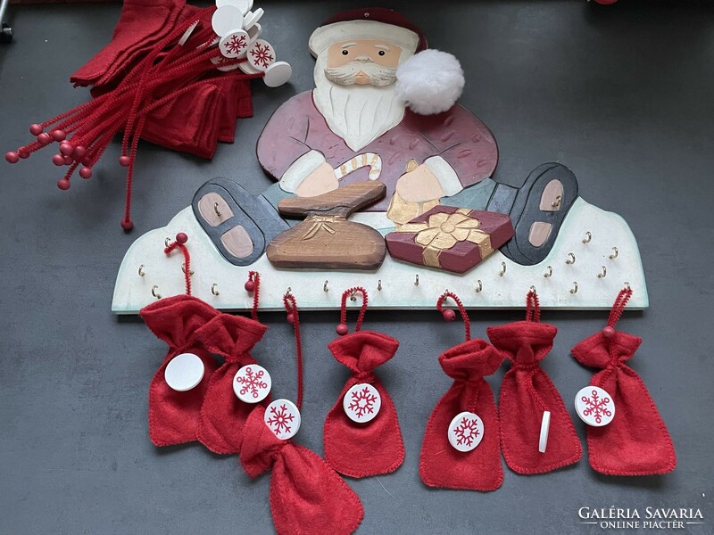 Santa's advent calendar made of wood with felt bags