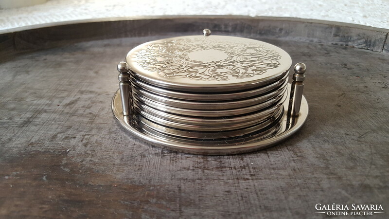 Silver-plated, chiseled metal coaster set