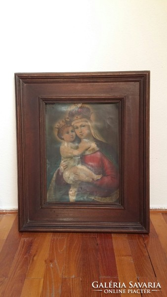 Old thick wooden frame with crowned Mary with the little Jesus