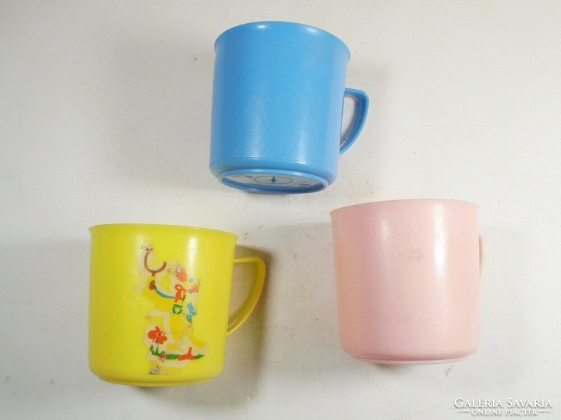 Retro old colorful plastic toothbrush children's cup DDR from the East German 1970s