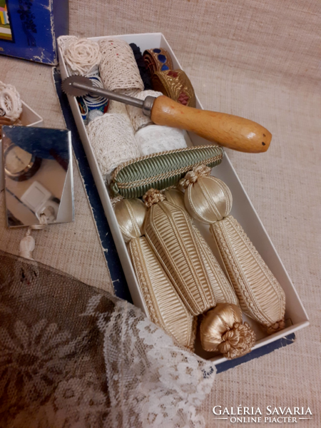 Old sewing equipment, beaten lace, buttons, lace edges, needle holder, post, horseshoe, table cloth, crochet hook