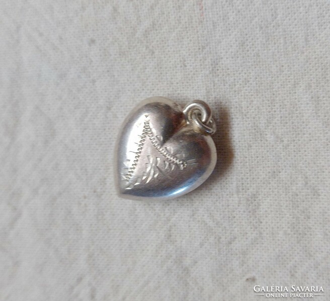 Classic antique heart-shaped engraved silver pendant.