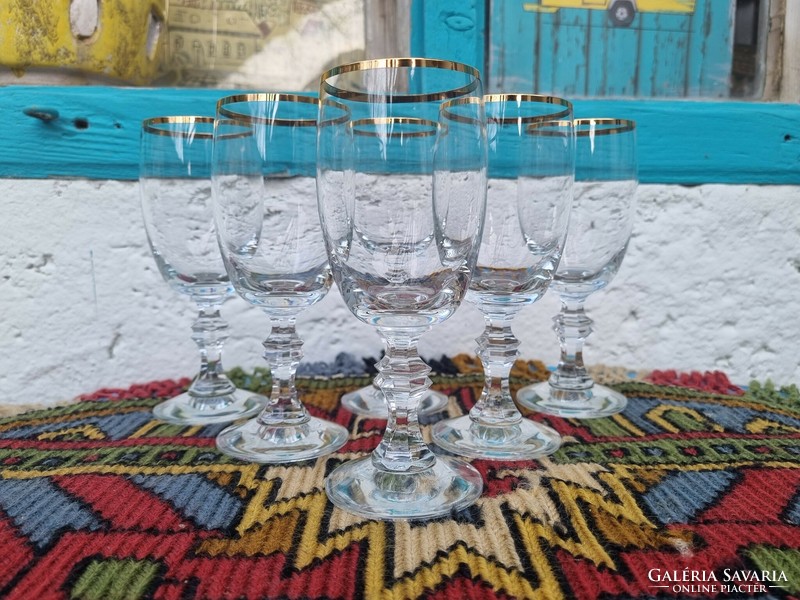 A wonderful set of hand-brushed glass glasses with gold rims