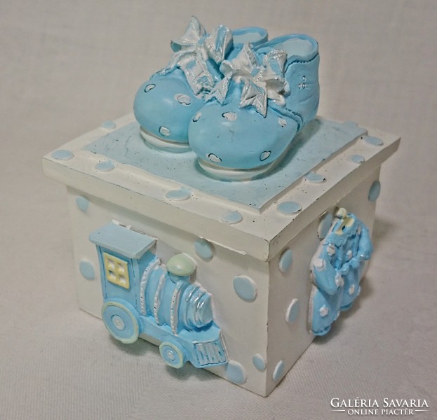 Bright baby blue shoes with a box hiding the letter. A beautiful gift for baby visits.