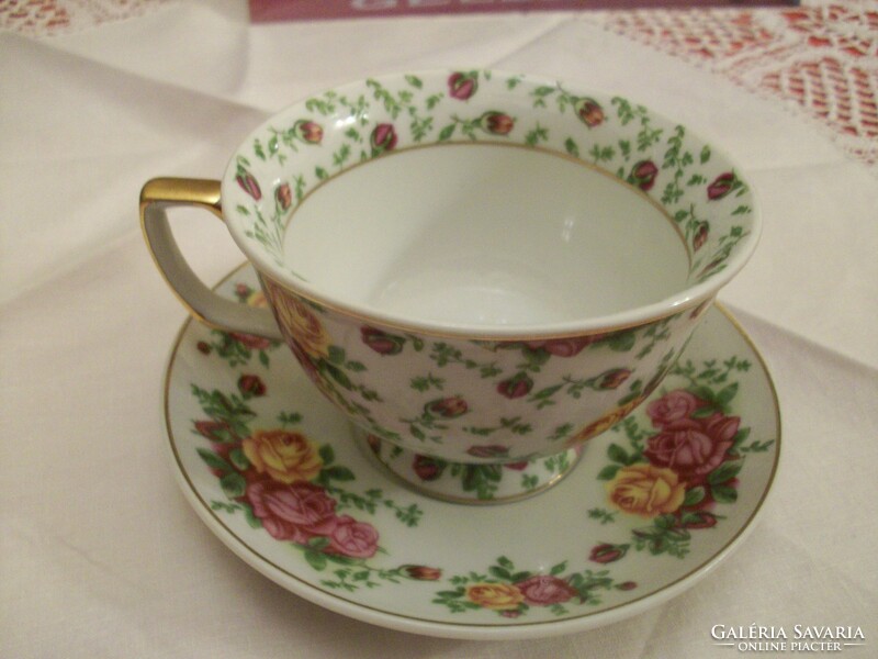 Beautiful porcelain tea cup with gilded rim and 2 pieces. With washer