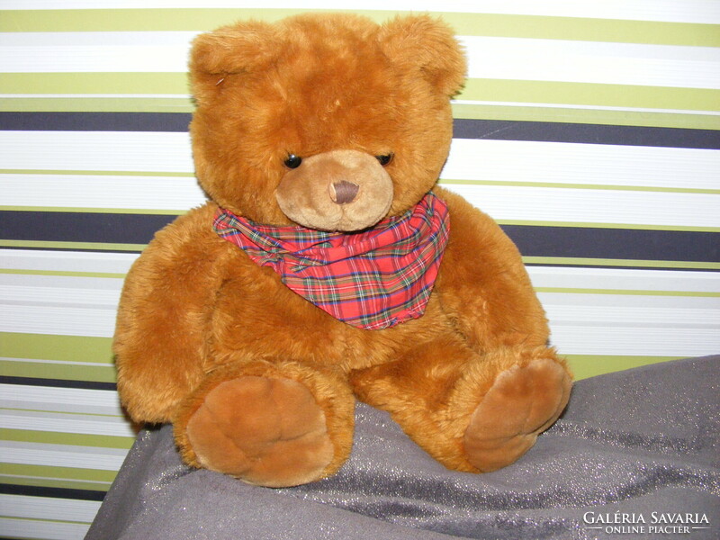 Big teddy bear with a checkered scarf
