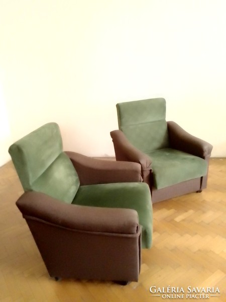 Two classically shaped, high-back two-color, dark brown, moss green armchairs with castors