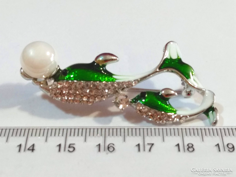 Betsey Johnson has two dolphin brooches