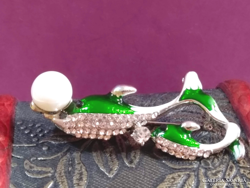 Betsey Johnson has two dolphin brooches