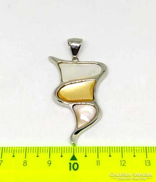 A mother-of-pearl pendant with shell inlay